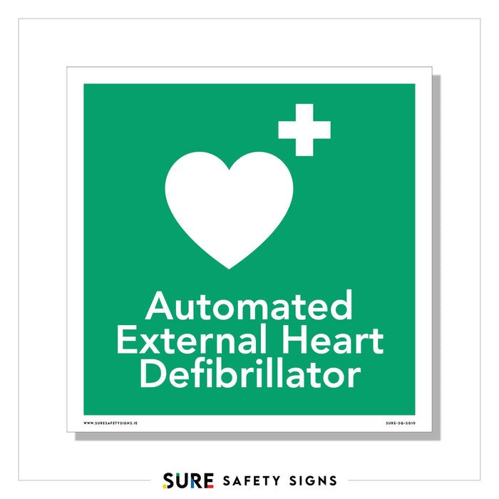 Green sign with a white heart and a plus symbol. Below, the text reads: Automated External Heart Defibrillator. This essential safety sign from Ireland features SURE SAFETY SIGNS in the logo at the bottom.