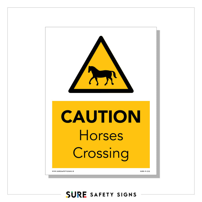 A high-visibility sign features a yellow triangle with a horse silhouette and the words CAUTION Horses Crossing set against the bright backdrop, ensuring drivers are alert to potential equestrian traffic ahead.