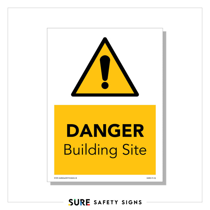 A danger sign with a black exclamation mark inside a yellow triangle above the words DANGER Building Site is prominently displayed on a white surface. This construction site safety sign features SURE SAFETY SIGNS at the bottom, ensuring all passersby heed its warning.