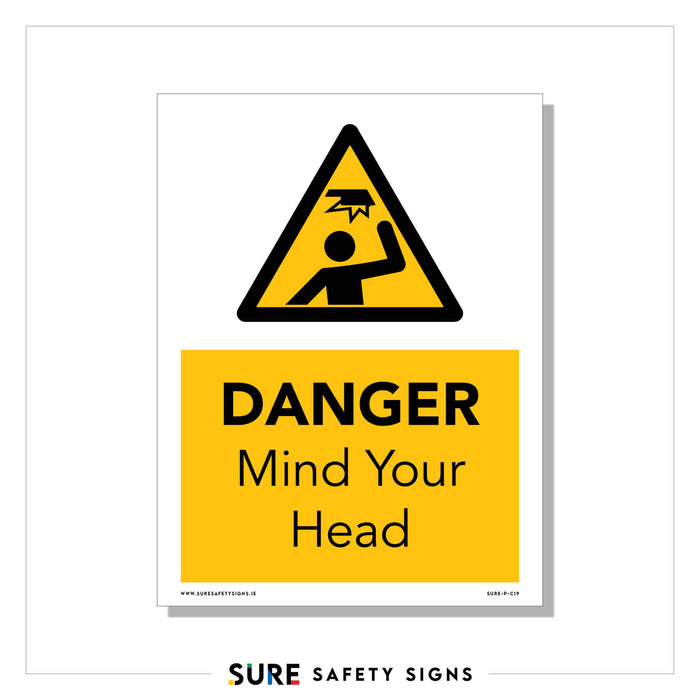 A safety sign with a triangular warning symbol features a person hitting their head, accompanied by the text DANGER: Mind Your Head on a yellow background. This danger sign from SURE SAFETY SIGNS is essential for head injuries prevention in hazardous areas.