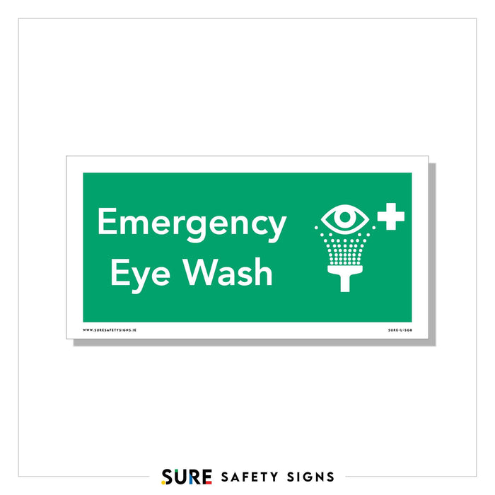 Green rectangular safety sign displaying Emergency Eye Wash in white text, accompanied by an icon of an eye above a water fountain, indicating the location of an eye wash station. Commonly seen across various facilities in Ireland to ensure swift response during emergencies.