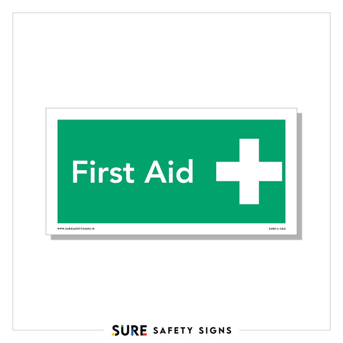 A rectangular First Aid sign with a green background displays the text First Aid in white, next to a white cross symbol. Complying with safety regulations, the bottom of the sign includes www.suresafetysigns.ie and product code SASS-FAS3.