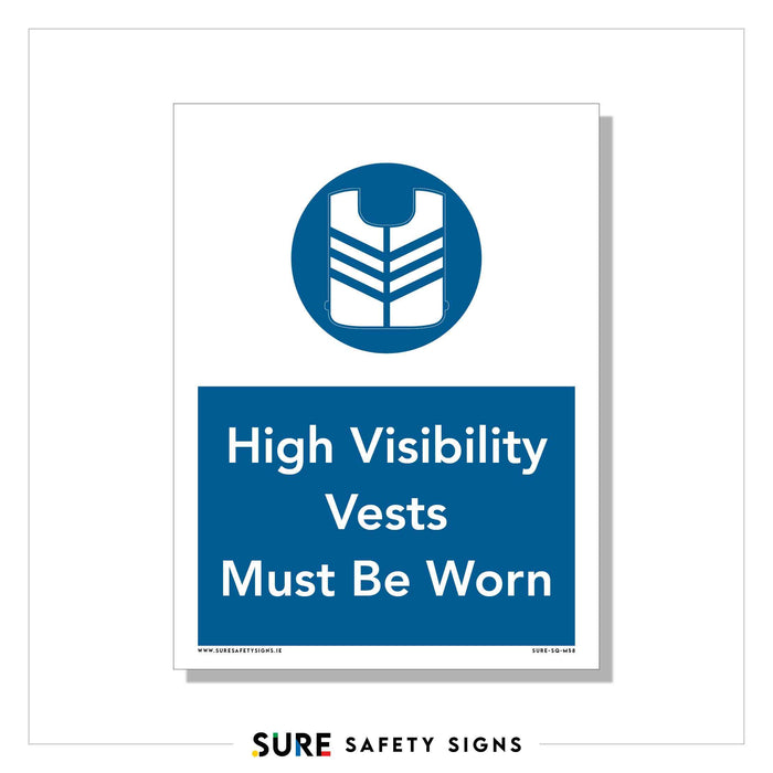 The safety sign, designed with a blue circle and vest icon, mandates High Visibility Vests Must Be Worn. It reflects Irelands commitment to safety and is bordered with the SURE SAFETY SIGNS brand at the bottom.