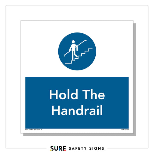 A safety sign with a blue circle features a stick figure walking on stairs, hand on the rail. Below, it reads Hold The Handrail. There is a website link at the bottom. Perfect for public spaces in Ireland where safety is priority.