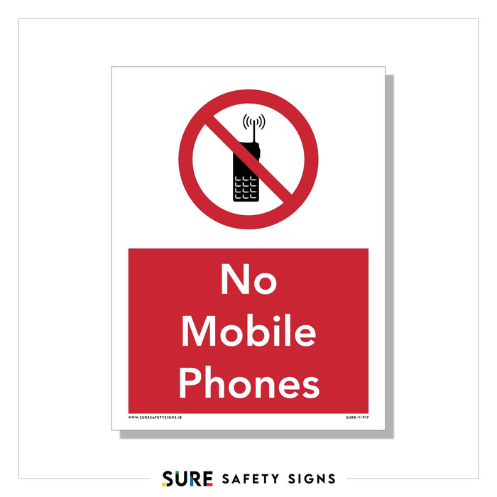 A safety sign, widely used in Ireland, features a crossed-out mobile phone icon inside a red circle. Below, the red rectangular box displays the text No Mobile Phones.
