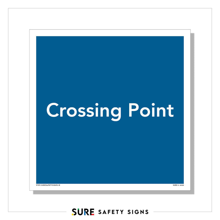 Blue sign with white text reading Crossing Point. The border and text are simple and straightforward, much like the safety signs commonly found across Ireland. Branding at the bottom reads SURE SAFETY SIGNS.