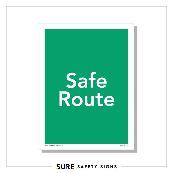 A green safety sign with white text reads Safe Route, marking one of the designated evacuation routes for a secure departure.