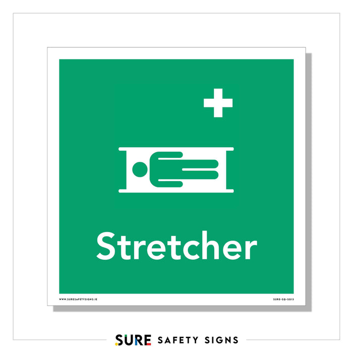 Green safety sign featuring a white icon of a person on a stretcher, accompanied by a white medical cross above. The word Stretcher is prominently displayed below the symbol, ensuring universal recognition and compliance with safety standards, including those in Ireland.