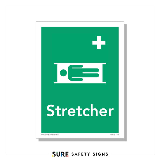 A green safety sign features a white symbol of a person on a stretcher, with a cross above it. Below the symbol, the word Stretcher is written in white. This design is reminiscent of similar signage used in Ireland for emergency situations.