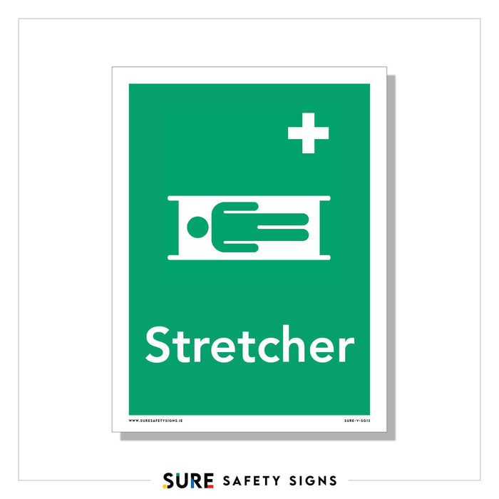 A green safety sign features a white symbol of a person on a stretcher, with a cross above it. Below the symbol, the word Stretcher is written in white. This design is reminiscent of similar signage used in Ireland for emergency situations.