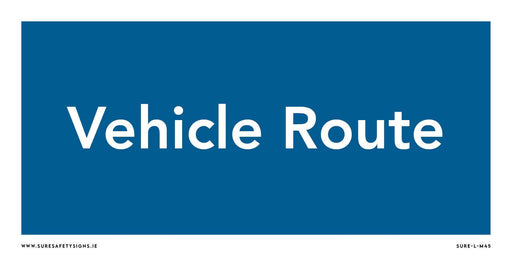 A rectangular blue safety sign with white text reading Vehicle Route adds a touch of order, much like those seen along the scenic roads of Ireland.