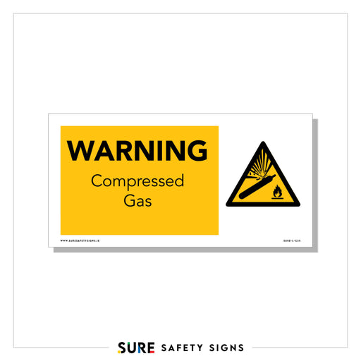 A safety sign with a yellow background in Ireland reads WARNING Compressed Gas. It features a triangular symbol showing a gas cylinder emitting a burst, beside a flame icon.